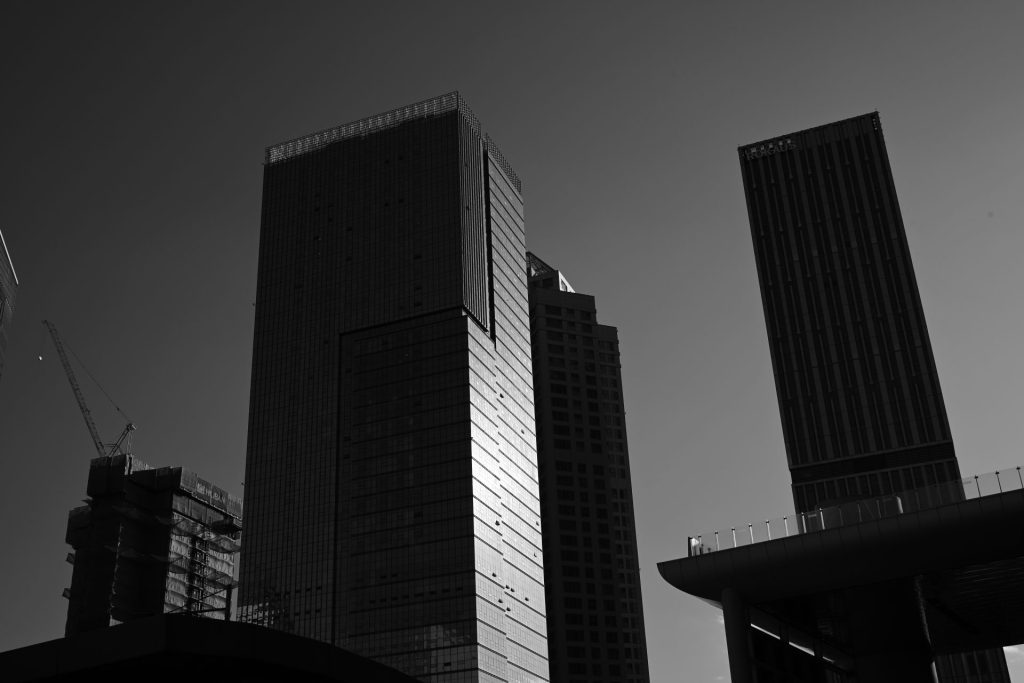 ein Schwarzweißfoto von zwei hohen Gebäuden