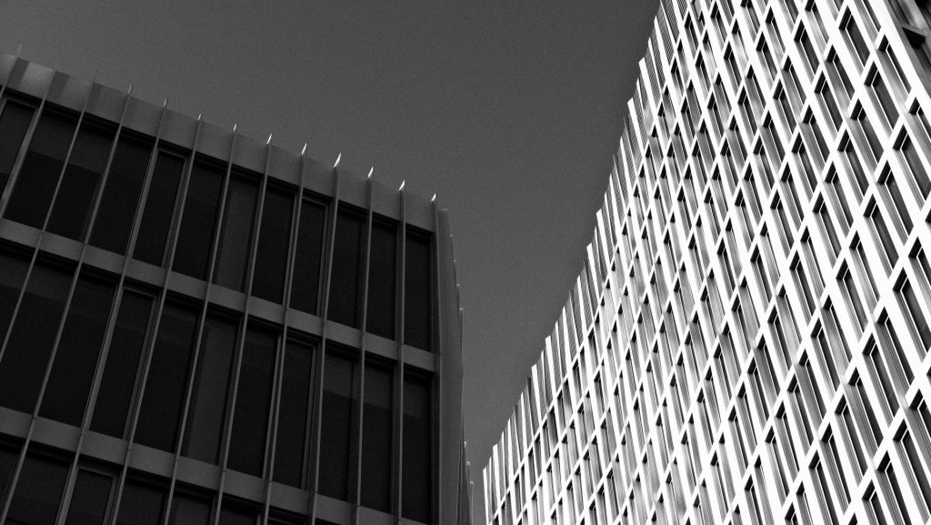 ein Schwarzweißfoto von zwei hohen Gebäuden